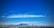 A panoramic view of Cape Town's coastline with Table Mountain in the background under a clear sky.