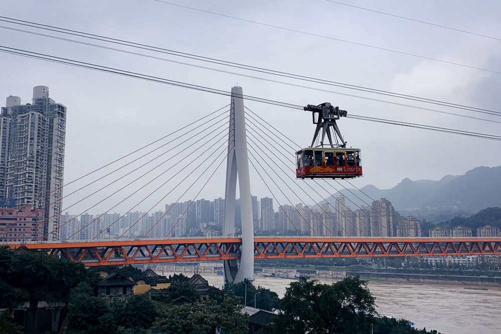 yellow and black cable cars over bridge