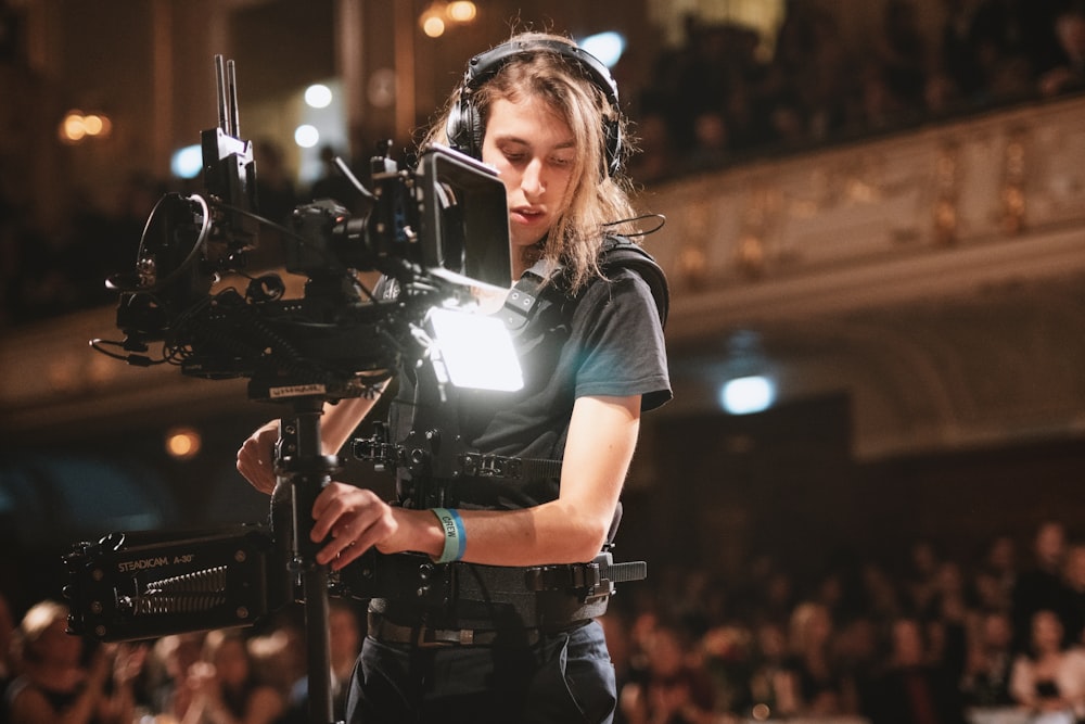 woman in black t-shirt holding black video camera