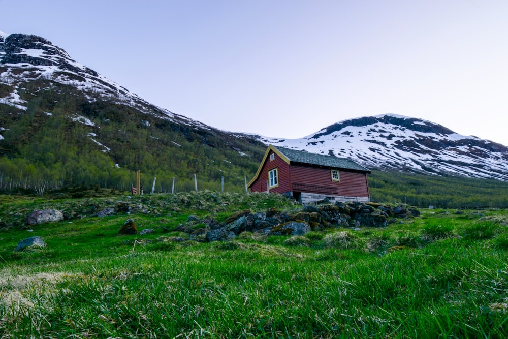 brown and white house near mountain under white sky during daytime