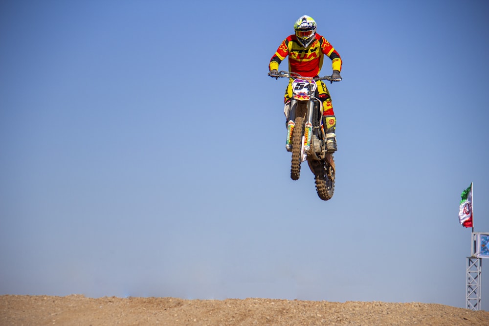 man in green and yellow motocross suit riding motocross dirt bike