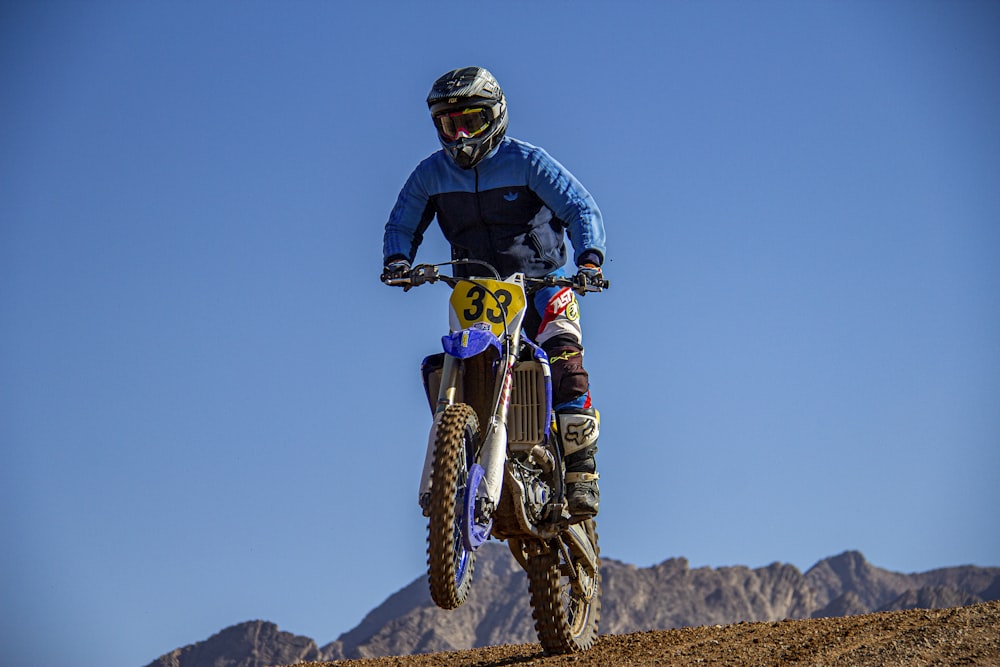 man in black helmet riding motocross dirt bike