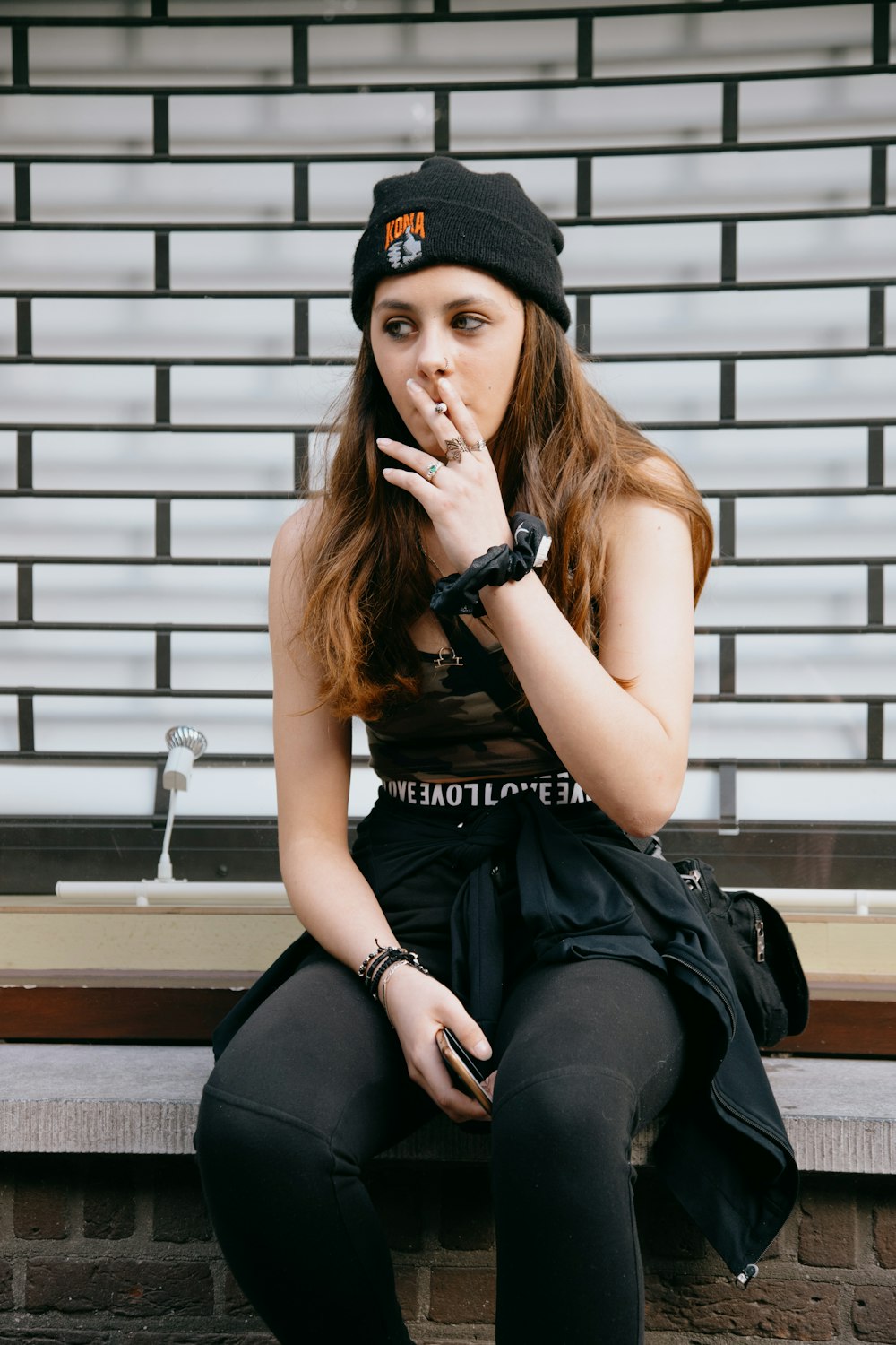 woman in black sleeveless dress sitting on stairs