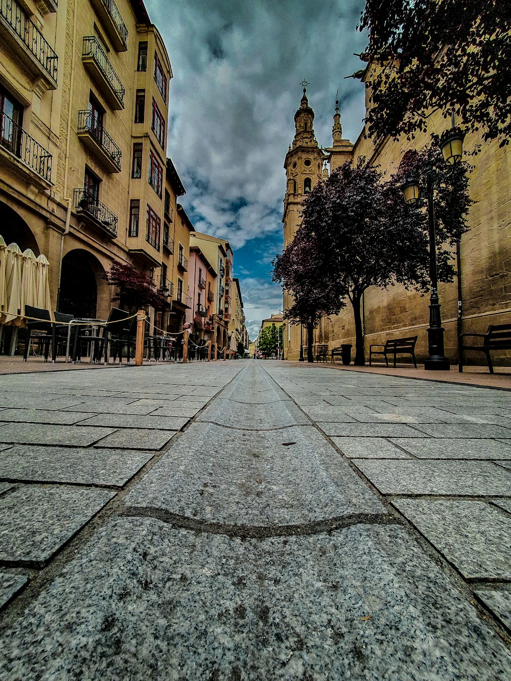 gray concrete pathway between brown concrete buildings during daytime