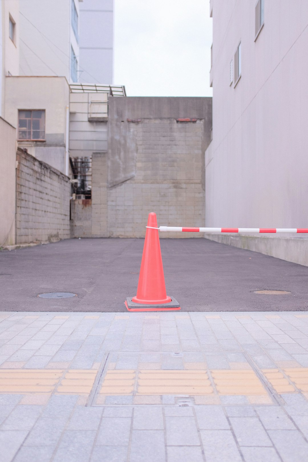 red traffic cone on gray concrete floor
