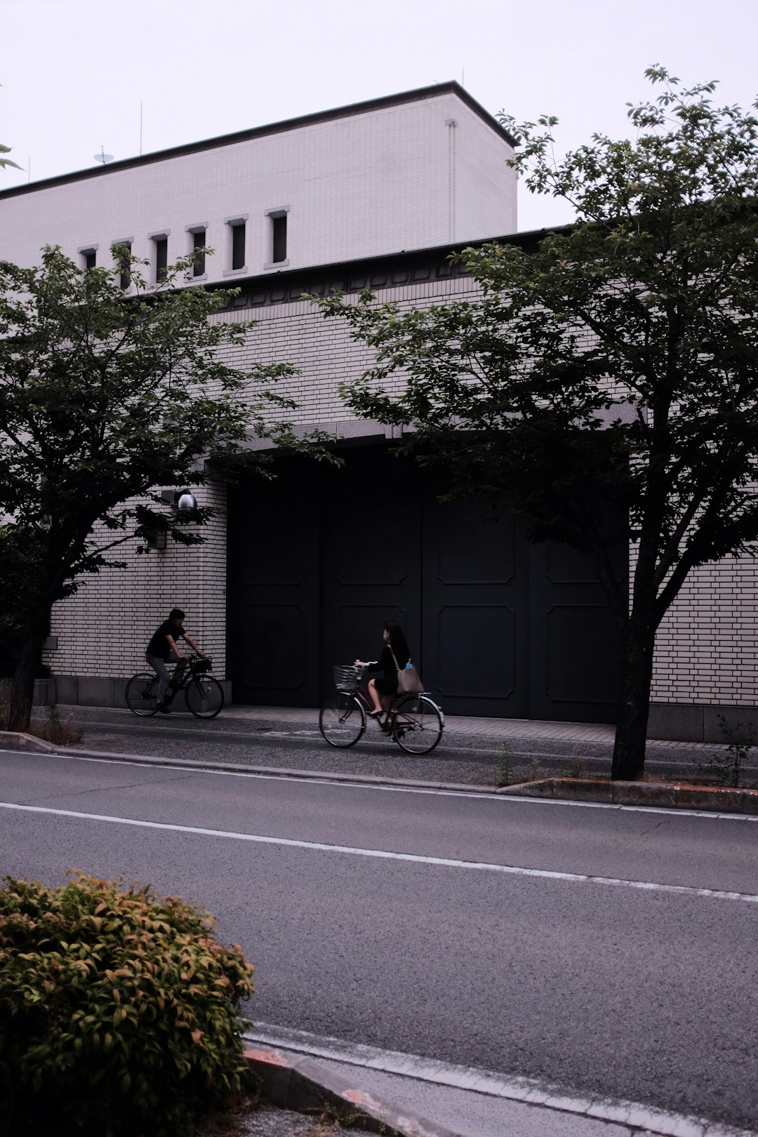 man in black jacket riding bicycle on road during daytime