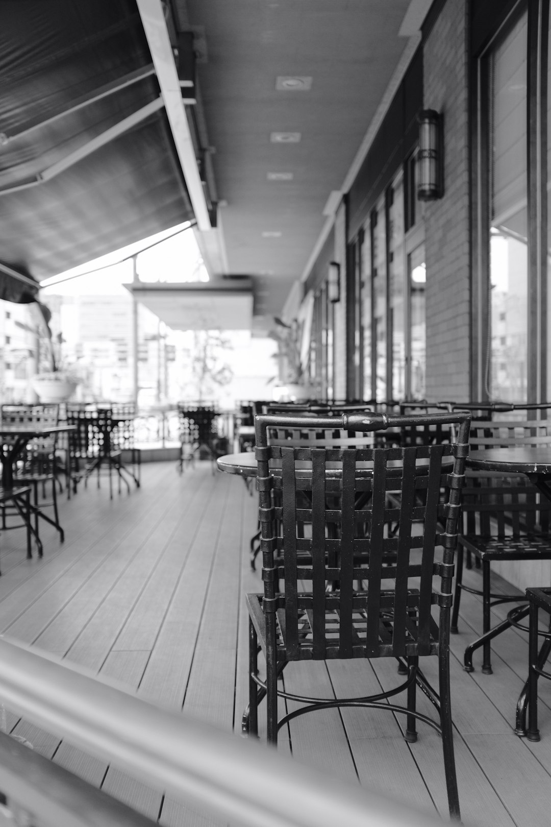 grayscale photo of dining table and chairs