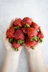 strawberries on persons hand