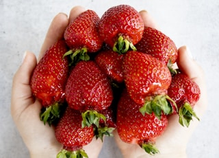 strawberries on persons hand