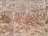 An arrangement of bricks forming a patterned design on a wall, featuring a mix of horizontal and diagonal placements creating geometric shapes. The bricks vary in shades of red and brown with some areas covered in mortar.