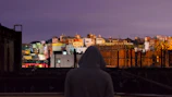Evening shot of a city skyline with a person in ufo69 gear blending into the urban vibe.