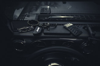 A compact emergency safety hammer placed inside a car glove box.