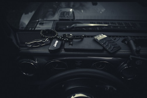 A compact emergency safety hammer placed inside a car glove box.