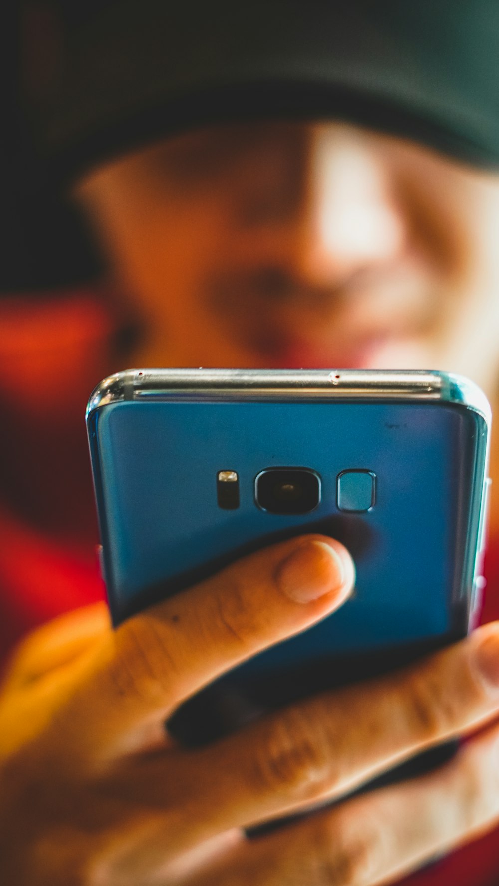 person holding blue iphone case