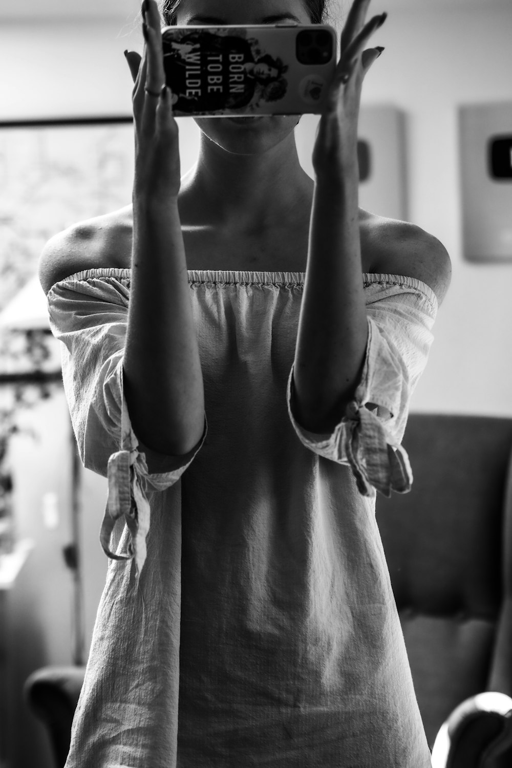 grayscale photo of woman in white long sleeve shirt