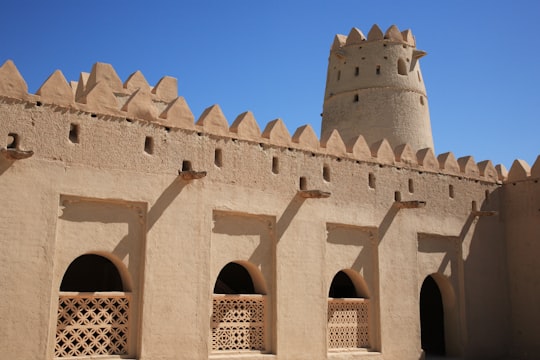 brown concrete building under blue sky during daytime in Al Jahili Fort United Arab Emirates