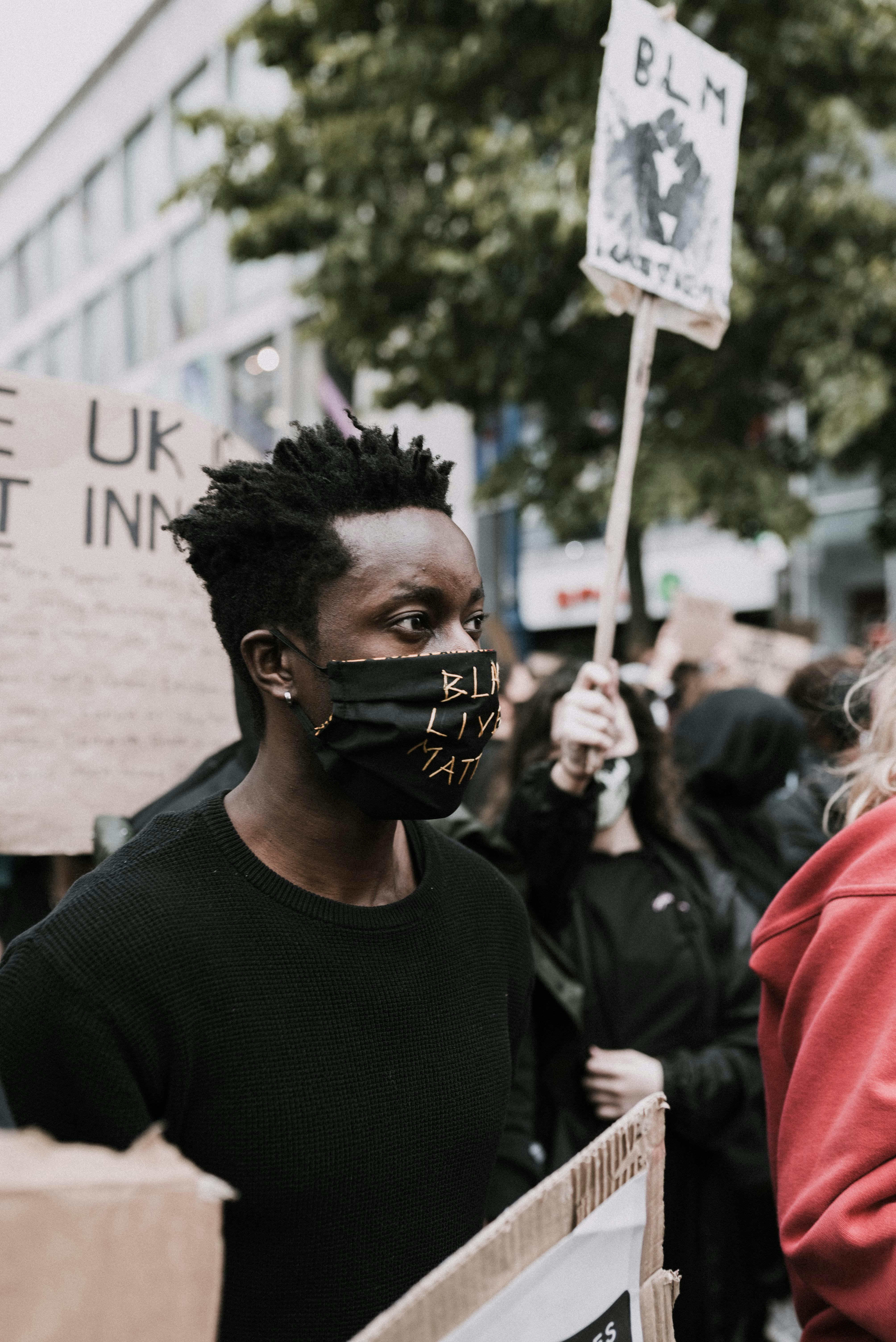 man in black crew neck shirt wearing black sunglasses