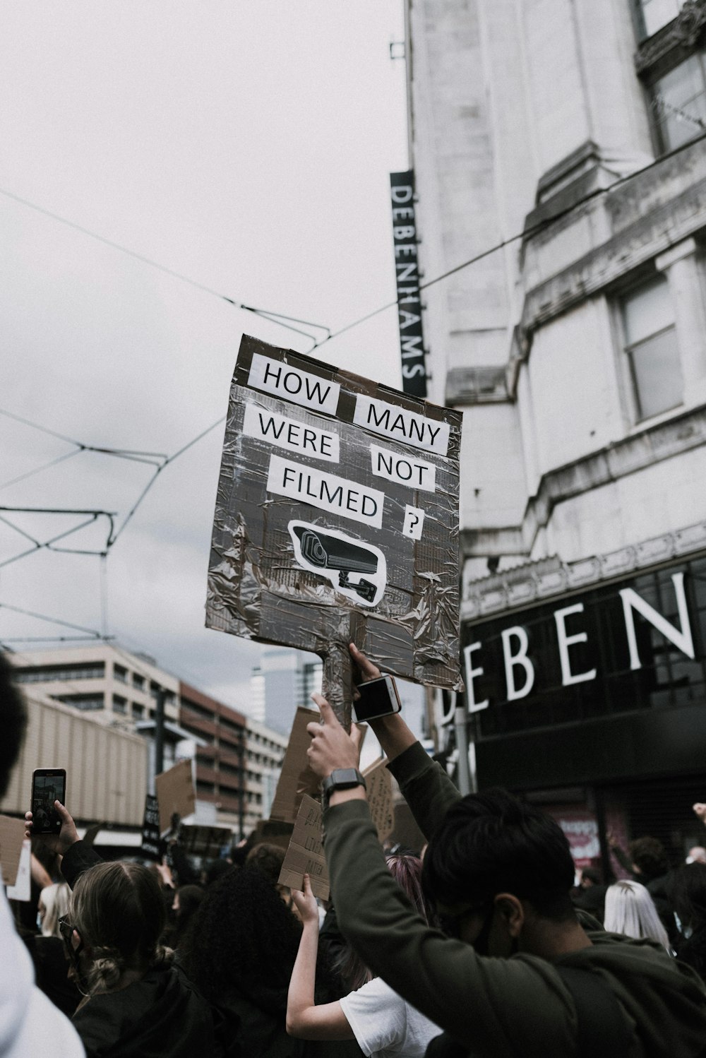 a group of people holding up signs in the air