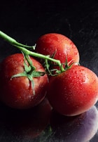 red tomato on black surface