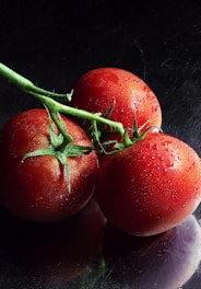 red tomato on black surface