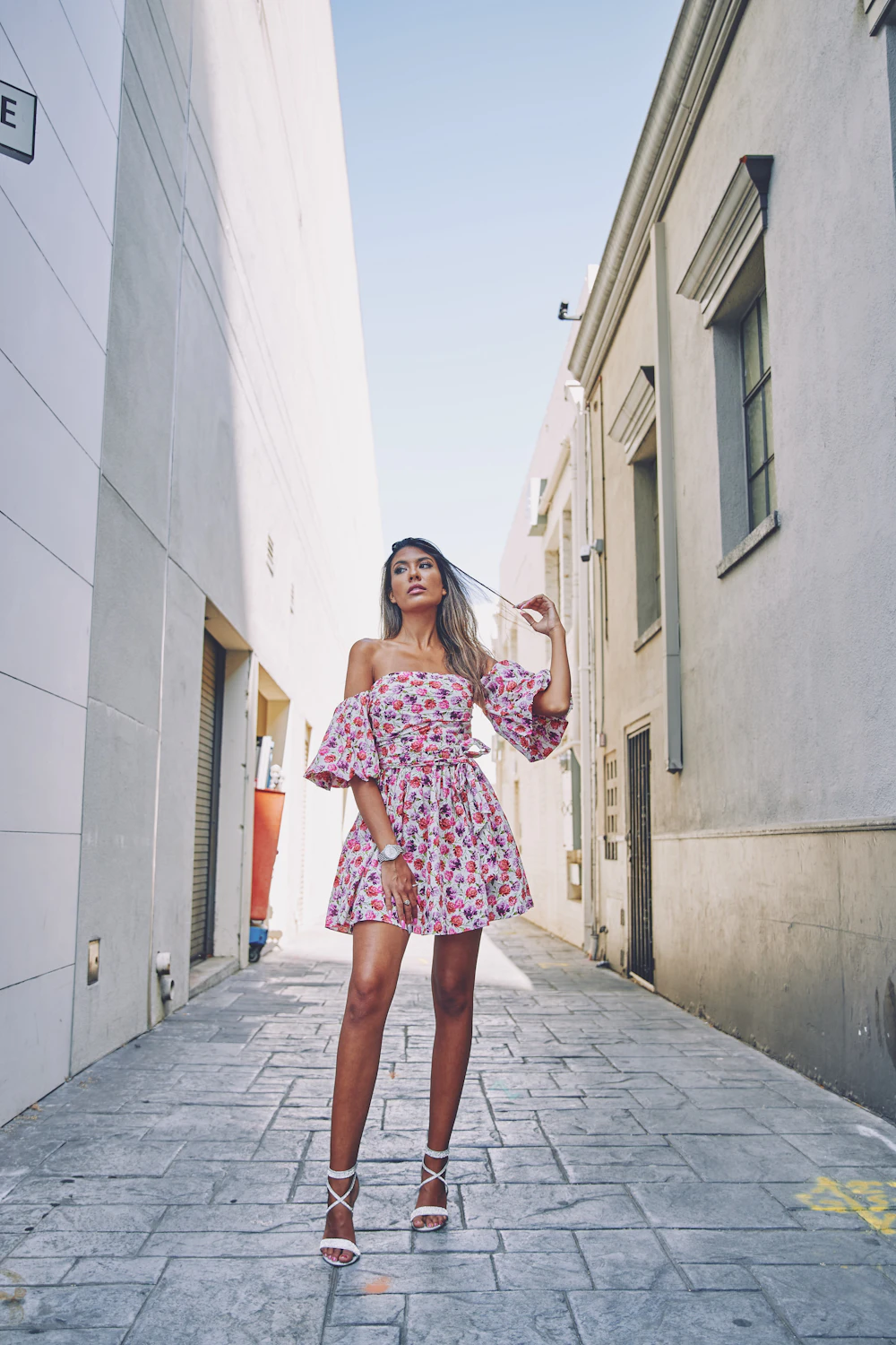 Woman wearing a pink floral print mini dress
