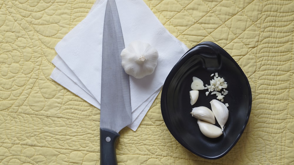 white flower on black round plate