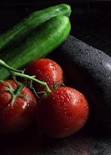 red tomato beside green cucumber