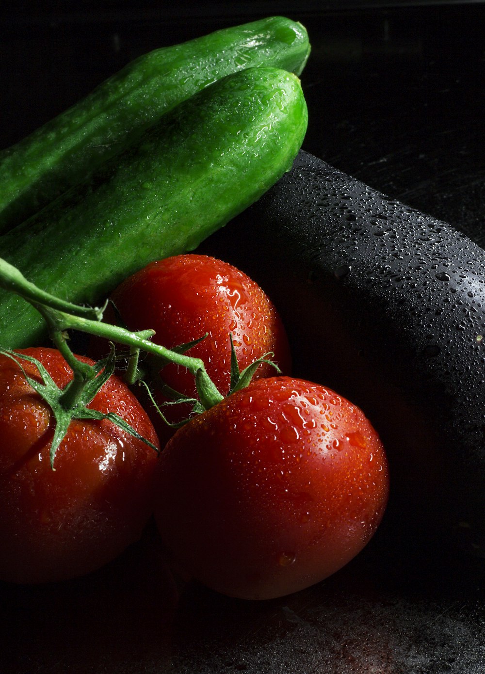 red tomato beside green cucumber