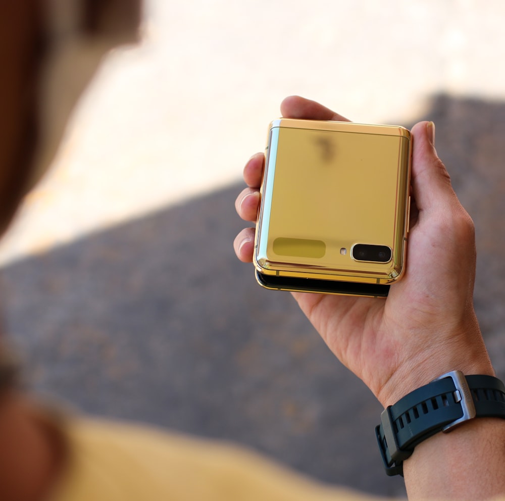 person holding gold iphone 6