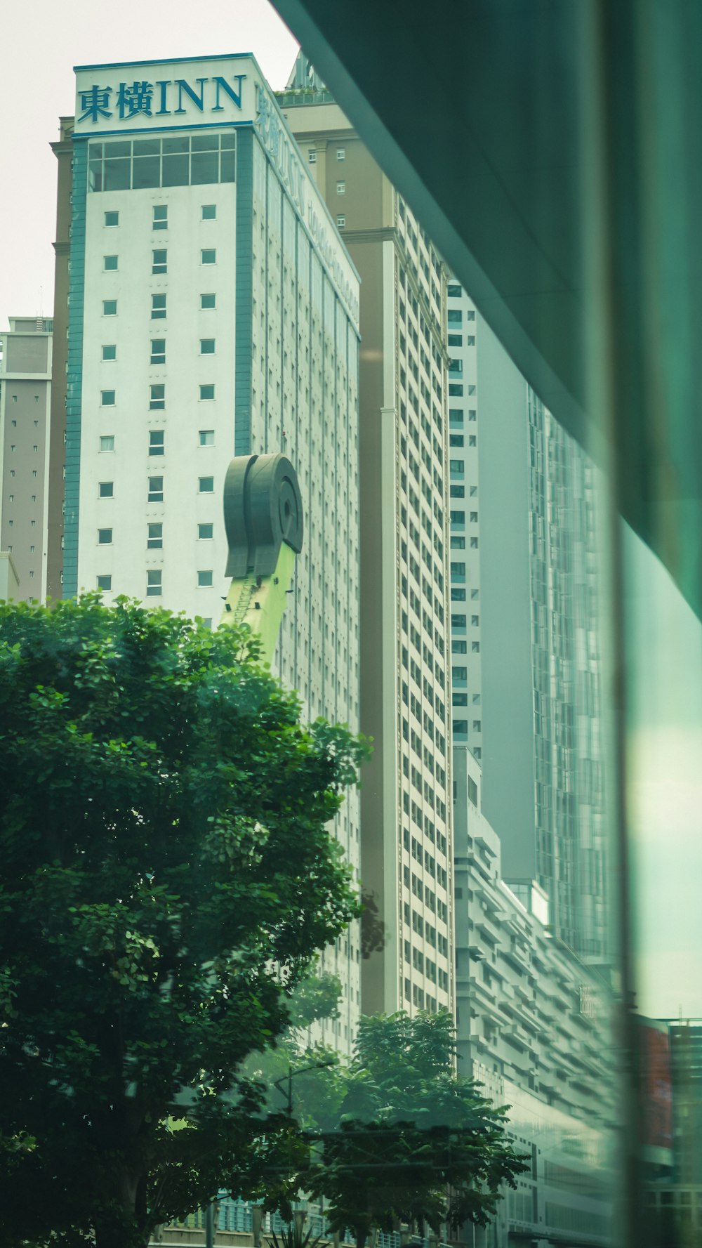 green trees near white concrete building during daytime