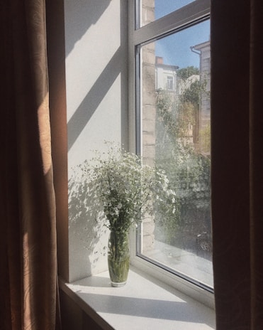 Cozy home corner featuring a vase with soap flowers and soft natural light coming through the window.