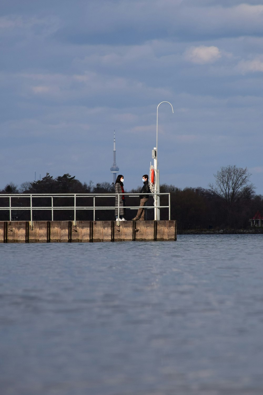 man in white shirt standing on dock during daytime