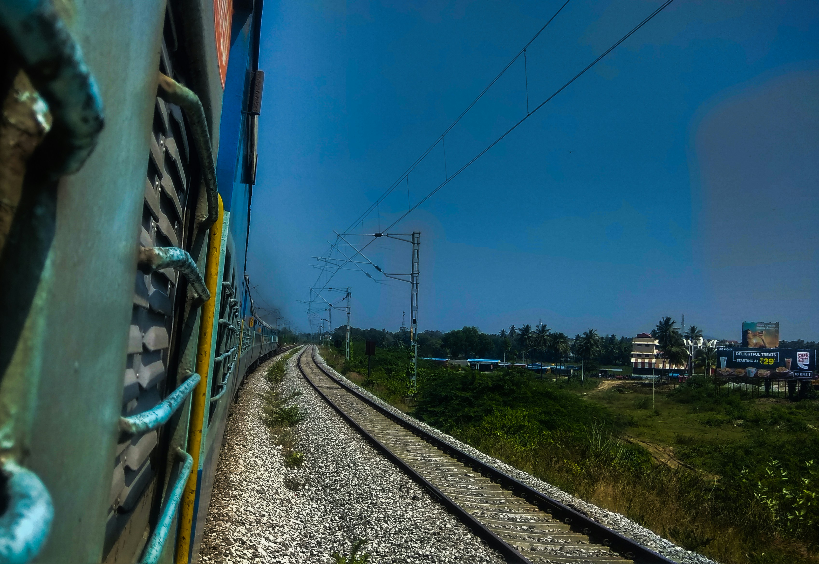 A close-up shot of a modern Indian train with a clear emphasis on its structure, perhaps a side view showcasing multiple compartments, in a station.