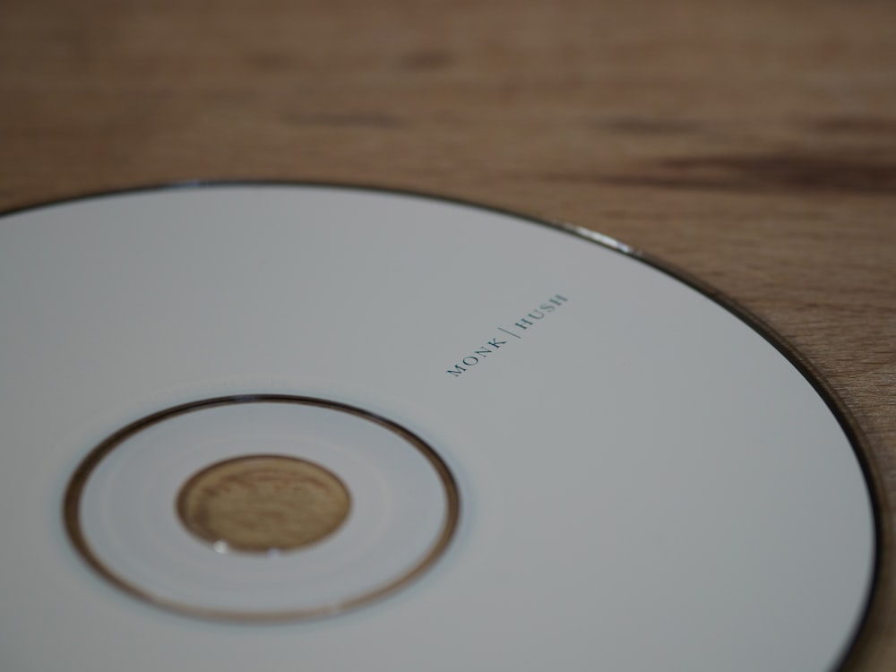 weiße Compact Disc auf braunem Holztisch