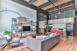 white leather couch on brown wooden parquet flooring