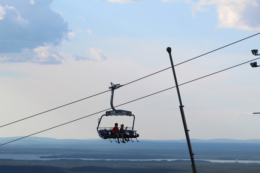 red cable car over the sea during daytime