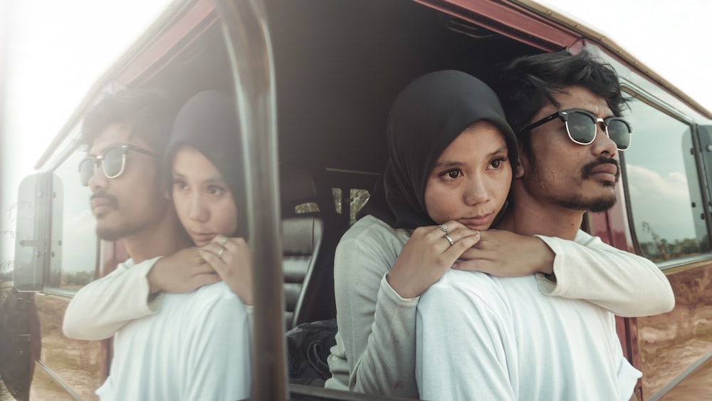 woman in black hijab carrying baby