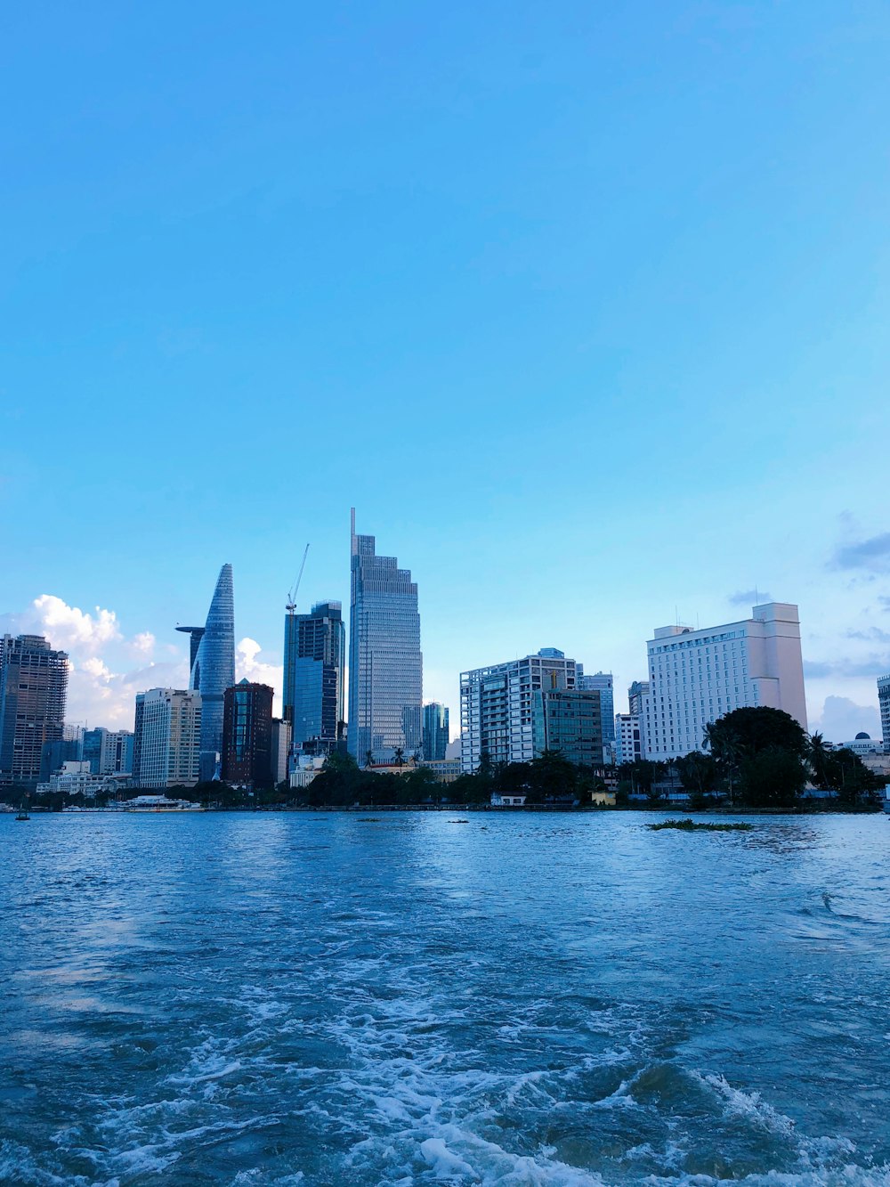 city skyline across body of water during daytime