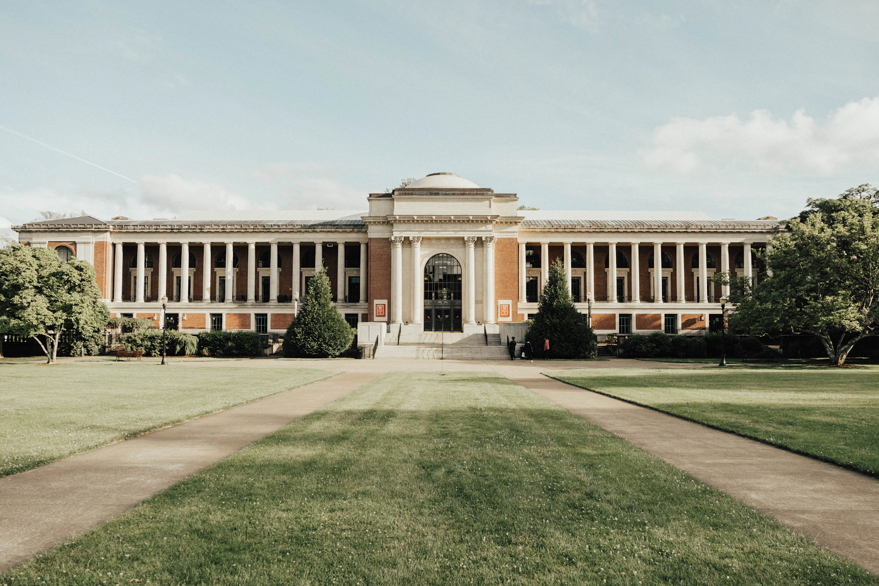 Historic university building across a green campus