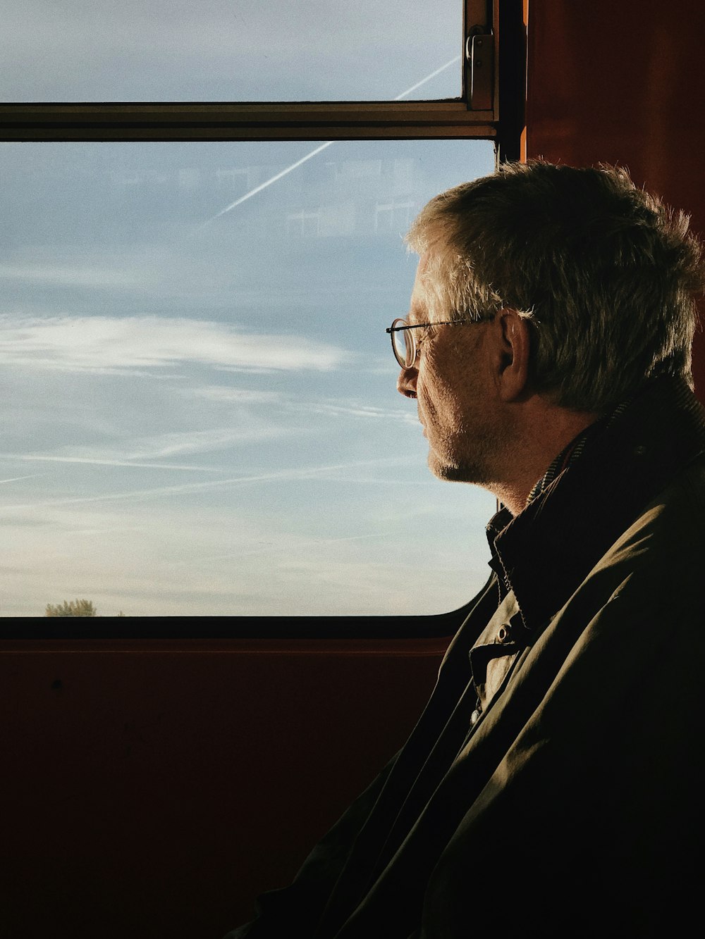 man in black jacket wearing eyeglasses