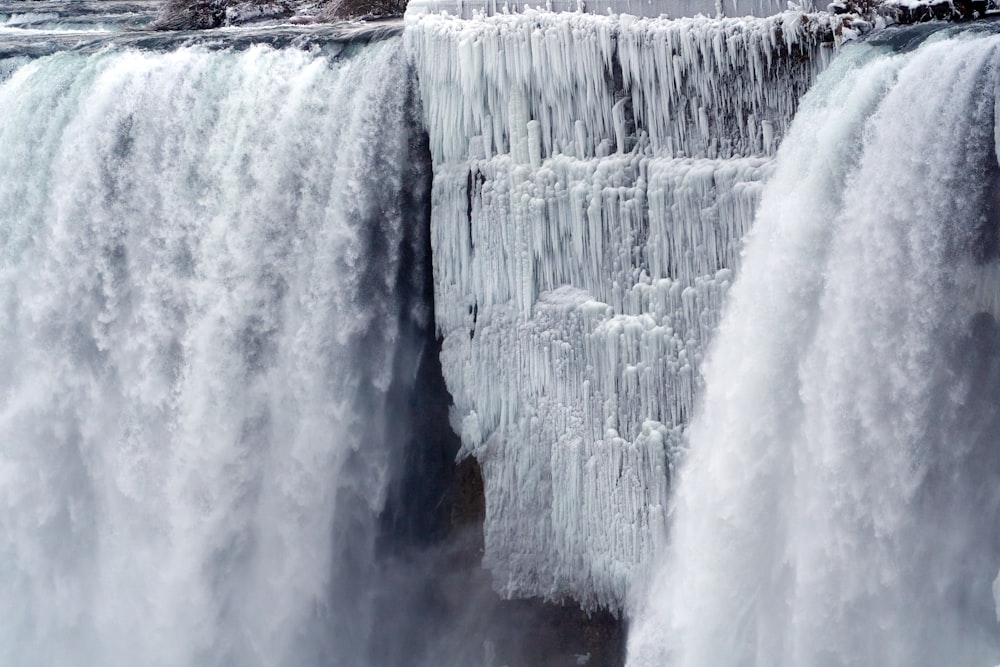 water falls on brown rocky mountain