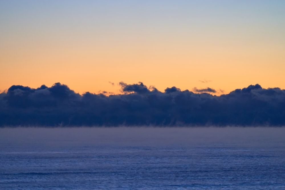 body of water under cloudy sky during daytime