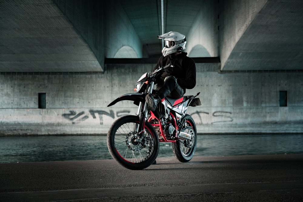 a man riding a motorcycle on top of a street