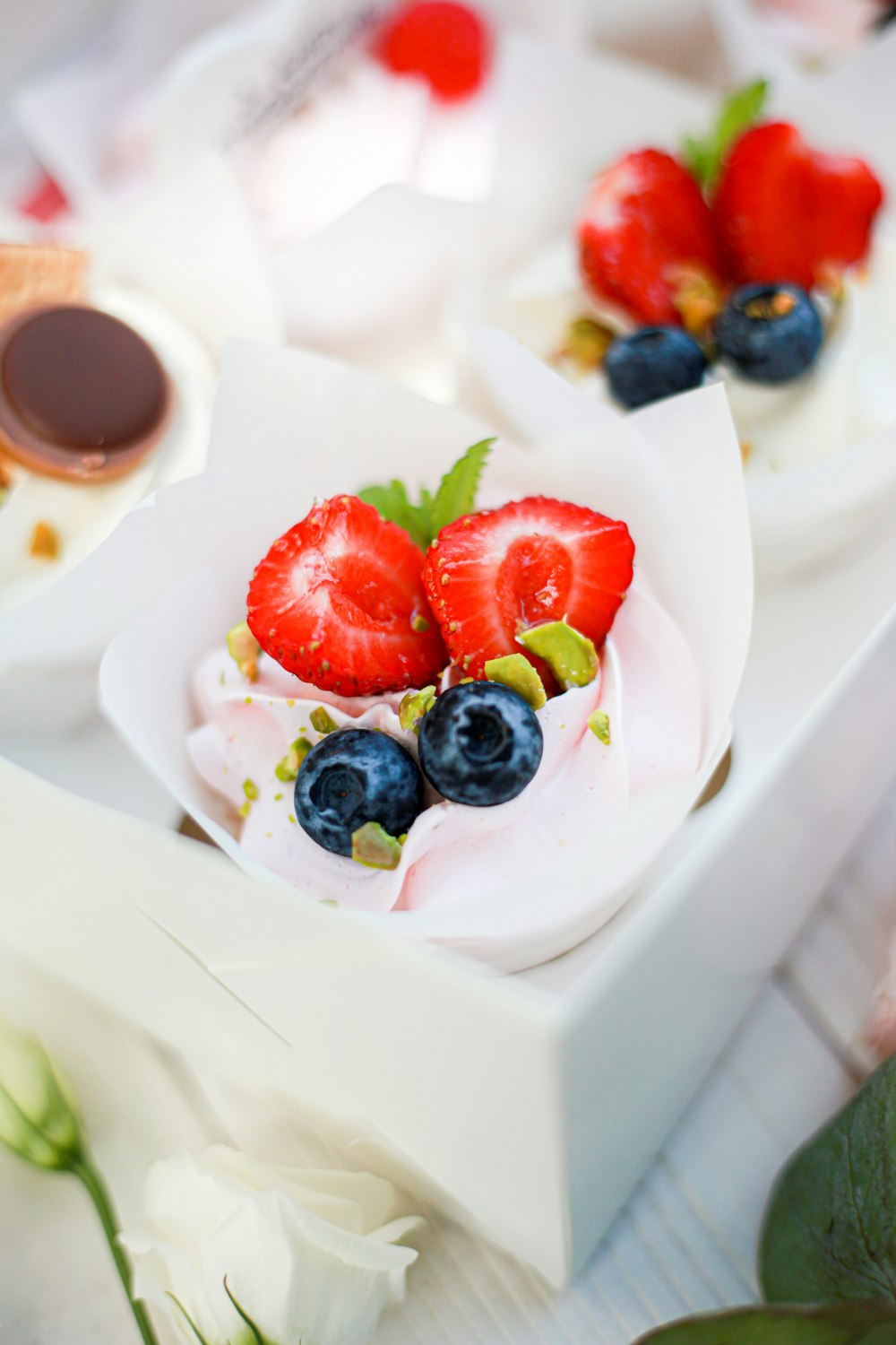 sliced strawberries and blueberries on white ceramic plate