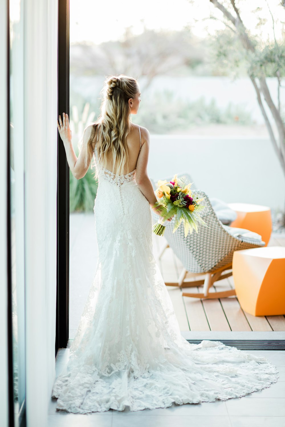 woman in white floral dress holding bouquet of flowers