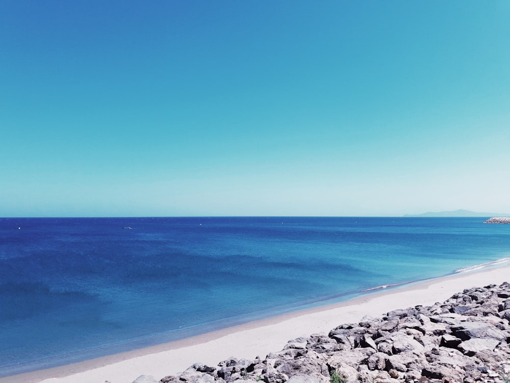 blue ocean water under blue sky during daytime