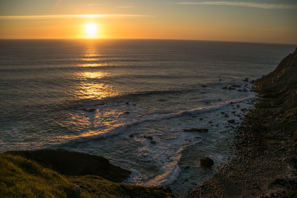 body of water during sunset