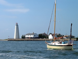 white and blue boat on sea during daytime