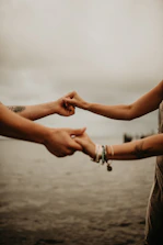 A comforting scene of two hands reaching out across a bridge symbolizing connection.