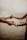 Two hands reaching out and holding each other, set against a serene background of a calm, blurred seascape. The image conveys a sense of connection and tenderness.